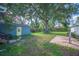 Backyard with a small storage shed, mature tree and brick patio at 549 Palencia Pl, Lakeland, FL 33803