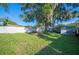 Backyard featuring a mature tree, green lawn and perimeter fencing at 549 Palencia Pl, Lakeland, FL 33803