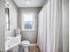 Compact bathroom with shower and tub, white toilet, sink, and medicine cabinet, featuring a small window at 549 Palencia Pl, Lakeland, FL 33803