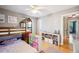 Bright bedroom featuring a bunk bed with ladder, colorful storage bins, hardwood floor, and plenty of light at 549 Palencia Pl, Lakeland, FL 33803