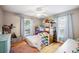 Bright bedroom featuring a bunk bed with ladder, storage bins, hardwood floor, and plenty of natural light at 549 Palencia Pl, Lakeland, FL 33803