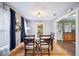 Bright dining room featuring hardwood floors and convenient access to the kitchen, ideal for entertaining at 549 Palencia Pl, Lakeland, FL 33803