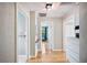 Bright hallway with hardwood floors and neutral walls leads to various rooms in the house at 549 Palencia Pl, Lakeland, FL 33803