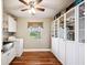 Bright laundry room with white cabinets, stainless steel sink, and washer/dryer beneath a decorative window at 549 Palencia Pl, Lakeland, FL 33803