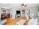 Bright living room showcasing hardwood floors, open layout, and easy access to the dining area and bathroom at 549 Palencia Pl, Lakeland, FL 33803