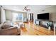 Inviting living area with natural light, hardwood floors, and open access to the dining space enhancing appeal at 549 Palencia Pl, Lakeland, FL 33803