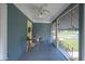 Charming enclosed porch featuring a yellow door, neutral decor, and an inviting space to unwind at 549 Palencia Pl, Lakeland, FL 33803