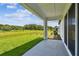 Expansive backyard patio provides ample space for outdoor relaxation with serene views of the green lawn at 6068 Sacred Oak Ave, Mount Dora, FL 32757