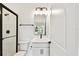 Bathroom with modern black hardware, shower with glass door and tile surround at 6068 Sacred Oak Ave, Mount Dora, FL 32757