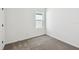 Bright, carpeted bedroom with natural light from a window at 6068 Sacred Oak Ave, Mount Dora, FL 32757