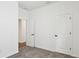 Bright bedroom features plush carpeting, neutral walls, and white paneled doors to a closet and other rooms at 6068 Sacred Oak Ave, Mount Dora, FL 32757