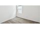 Neutral carpeted bedroom with natural light from a picture window at 6068 Sacred Oak Ave, Mount Dora, FL 32757