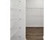 Spacious walk-in closet with white wire shelves and wood-look flooring at 6068 Sacred Oak Ave, Mount Dora, FL 32757