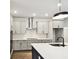 Stylish kitchen with updated cabinetry, stainless steel appliances, a large island, and modern lighting at 6068 Sacred Oak Ave, Mount Dora, FL 32757