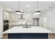 Stunning kitchen with an island, stainless steel appliances, sleek pendant lighting, and ample cabinet space at 6068 Sacred Oak Ave, Mount Dora, FL 32757
