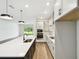 Bright kitchen with white cabinets, a large island, stainless steel appliances, and an open-concept layout at 6068 Sacred Oak Ave, Mount Dora, FL 32757