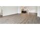 Bright and airy living room with wood-look floors leading to an open-concept kitchen area at 6068 Sacred Oak Ave, Mount Dora, FL 32757