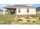 Backyard with an outdoor covered seating area perfect for entertaining, complemented by a well-manicured lawn at 887 Galloway St, Lake Alfred, FL 33850