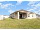 Spacious backyard featuring a covered patio, perfect for outdoor relaxation and entertaining at 887 Galloway St, Lake Alfred, FL 33850