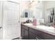 A nice bathroom with dual sinks, granite countertops, and modern vanities at 887 Galloway St, Lake Alfred, FL 33850