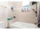 Bright bathroom featuring a tub with tile surround, shower head and other bathroom accessories and necessities at 887 Galloway St, Lake Alfred, FL 33850