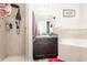 This bathroom has a shower, dark vanity, and a decorative mirror and is spacious at 887 Galloway St, Lake Alfred, FL 33850