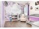 This is a nicely decorated bedroom with floral wallpaper, changing table and a crib at 887 Galloway St, Lake Alfred, FL 33850