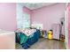 This is a fun bedroom with a pink theme, a daybed, and a playful decor at 887 Galloway St, Lake Alfred, FL 33850