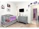 A bedroom with a crib, a dresser and a tv is perfect for a Bedroom at 887 Galloway St, Lake Alfred, FL 33850