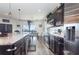 Open kitchen featuring granite countertops, stainless steel appliances, and views into the dining area at 887 Galloway St, Lake Alfred, FL 33850