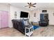 Cozy living room with modern decor, wood-look floors, ceiling fan, and comfortable seating at 887 Galloway St, Lake Alfred, FL 33850
