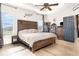 This is a great main bedroom with a ceiling fan, wood flooring and a rustic headboard at 887 Galloway St, Lake Alfred, FL 33850