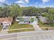Aerial view of a cozy home featuring a well-kept lawn and a convenient attached garage at 446 Eagle Cir, Casselberry, FL 32707