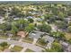 An aerial shot of a community dotted with mature trees, a swimming pool and quaint homes at 446 Eagle Cir, Casselberry, FL 32707