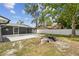 Large backyard with screened in patio and white vinyl fence, offering privacy at 446 Eagle Cir, Casselberry, FL 32707