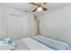 Bright bedroom with nautical bedding, featuring closet space and a ceiling fan at 446 Eagle Cir, Casselberry, FL 32707