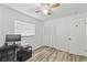 Bright bedroom with wood-look floors and ceiling fan with light kit at 446 Eagle Cir, Casselberry, FL 32707