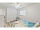 Comfortable bedroom with a tropical-themed bedspread, chair, and closet at 446 Eagle Cir, Casselberry, FL 32707
