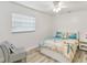 Cozy bedroom features white walls, wood-look floors, and beach-themed decor at 446 Eagle Cir, Casselberry, FL 32707