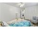 Comfortable bedroom with a tropical-themed bedspread, chair, and closet at 446 Eagle Cir, Casselberry, FL 32707