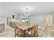 Dining room with wood table and decorative lighting, seamlessly connected to a modern kitchen at 446 Eagle Cir, Casselberry, FL 32707