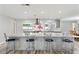 Bright kitchen with a spacious island, modern appliances, and stylish bar stool seating at 446 Eagle Cir, Casselberry, FL 32707