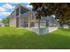 A spacious backyard features a screened-in lanai, perfect for outdoor entertaining and enjoying the green space at 886 Suffolk Pl, Davenport, FL 33896