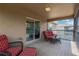 Relaxing screened balcony with comfortable seating and a view of the surrounding area at 886 Suffolk Pl, Davenport, FL 33896