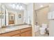 Bright bathroom with a granite countertop vanity, a bathtub with shower, and neutral tile flooring at 886 Suffolk Pl, Davenport, FL 33896