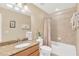 Bright bathroom features a granite countertop, tile shower, and neutral color palette at 886 Suffolk Pl, Davenport, FL 33896
