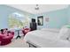 bedroom with twin beds, whimsical decor, and a bright, cheerful ambiance enhanced by natural light at 886 Suffolk Pl, Davenport, FL 33896