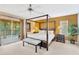 Well-lit bedroom with a king bed, balcony access, and a neutral color scheme at 886 Suffolk Pl, Davenport, FL 33896