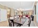 Spacious dining room featuring an elegant chandelier, large table, and an open layout to the living room at 886 Suffolk Pl, Davenport, FL 33896