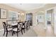 Formal dining room with a large table, elegant chairs, and an arched doorway leading to the entryway at 886 Suffolk Pl, Davenport, FL 33896
